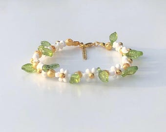 Handgjort armband i rostfritt stål med prästkrage, guldblomma och blad