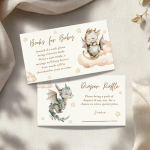 May include: Two baby shower invitation cards. One card reads "Books for Baby" with a dragon illustration. The other card reads "Diaper Raffle" with a dragon illustration. Both cards have star and cloud accents.