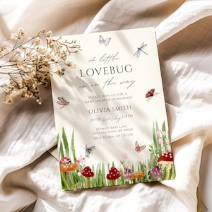 May include: Baby shower invitation in cream with watercolour illustrations of insects and mushrooms. The text reads "A little LOVEBUG is on the way" and includes event details for Olivia Smith, including the date and time.