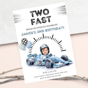May include: A birthday invitation card featuring the text TWO FAST and JAMES'S 2ND BIRTHDAY. The design includes a child in a helmet driving a light blue race car with the number 2, a speedometer graphic, and three balloons in blue and checkered patterns.
