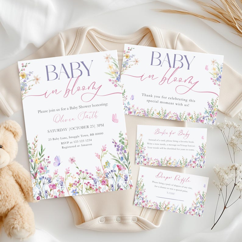May include: Baby shower invitations and cards with floral and butterfly accents. The invitation reads "Baby in Bloom" and includes event details. A teddy bear and baby onesie are in the background.