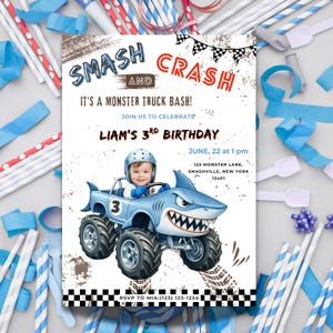 May include: A birthday party invitation with the text "SMASH AND CRASH" and "IT'S A MONSTER TRUCK BASH!". The invitation features a blue monster truck with a shark design, the number 3, and the text "LIAM'S 3RD BIRTHDAY".