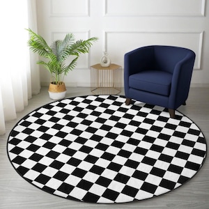 May include: A round rug with a black and white checkerboard pattern. The rug is placed on a light-colored wooden floor. A navy blue armchair and a small gold side table are in the background. A potted plant is also visible.