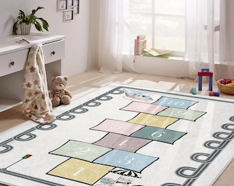 May include: A rectangular hopscotch rug with a white background and colourful squares numbered 1 to 10. The rug features a whimsical design with a bicycle and a road border, ideal for a child's playroom.