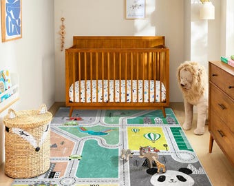 May include: A nursery with a wooden crib, a road-themed play rug, and a woven basket. The rug features a panda, zoo, and roads. A stuffed lion stands near a wooden dresser. The room has a neutral color palette.