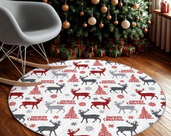 May include: A round Christmas rug with a white background featuring a pattern of reindeer, Christmas trees, and snowflakes in red, gray, and black. The words "Merry Christmas" are also printed on the rug.