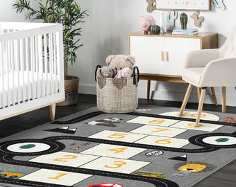May include: A grey and black play mat with a road and numbers 1-9. The mat features a panda, a lion, and a school bus.