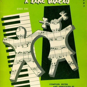 May include: A green book cover with the title "i like duets" in white text. The book is for piano and features a black and white piano keyboard and two figures made from sheet music. The text "Book One" is below the title and the text "Compiled, Edited and Annotated by David Hirschberg" is at the bottom of the cover.