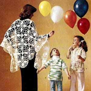 May include: A family of three wearing crocheted garments. The woman is wearing a white crocheted shawl, the girl is wearing a green and white striped crocheted top, and the younger girl is wearing a white crocheted top and pants. The family is holding onto strings attached to balloons.