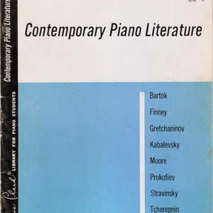 May include: A blue book cover with the title "Contemporary Piano Literature" and the text "Library for Piano Students" on the spine. The cover also lists the composers Bartók, Finney, Gretchaninov, Kabalevsky, Moore, Prokofiev, Stravinsky, and Tcherepnin.