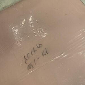 May include: A pink plastic bag with handwritten text that says "1911" and "231" in black marker.