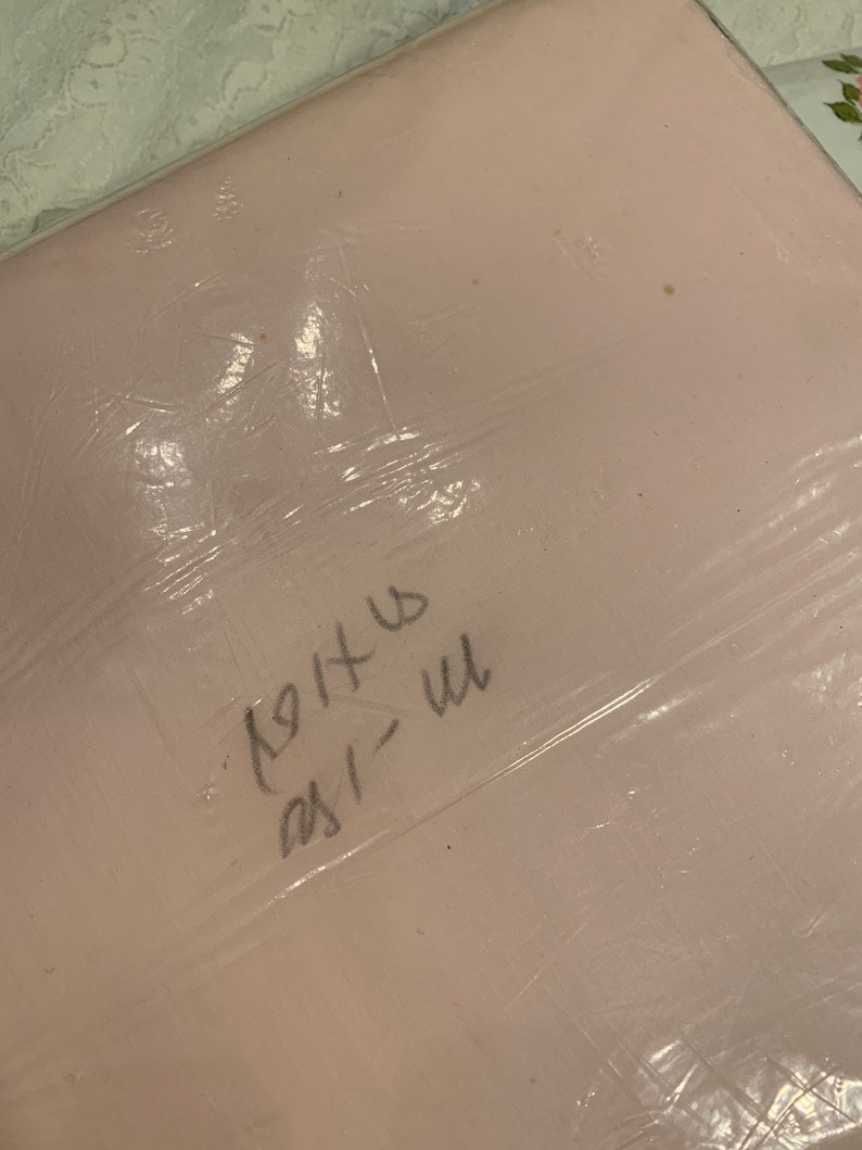 May include: A pink plastic bag with handwritten text that says "1911" and "231" in black marker.