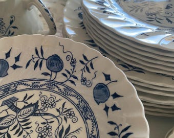 May include: A set of blue and white china dinnerware with a floral pattern. The set includes a teapot, sugar bowl, and several plates.