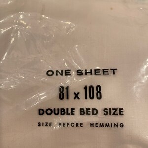 May include: A white sheet with black text that reads "ONE SHEET 81 x 108 DOUBLE BED SIZE SIZE BEFORE HEMMING".