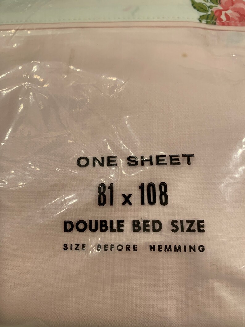 May include: A white sheet with black text that reads "ONE SHEET 81 x 108 DOUBLE BED SIZE SIZE BEFORE HEMMING".