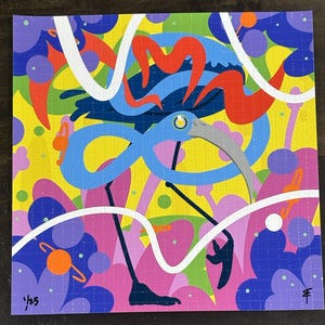 May include: A colorful, psychedelic art print featuring a stylized blue bird with a long, curved beak. The artwork is set against a vibrant background of yellow, purple, and pink, with white wavy lines and the text "1/25".