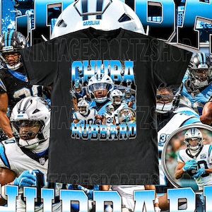 May include: Black t-shirt featuring a collage of football players in blue and white uniforms. The shirt has the text "CHUBA HUBBARD" in a blue and white gradient design. The background includes a football helmet.