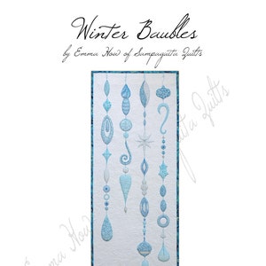May include: A quilted wall hanging titled "Winter Baubles" featuring light blue and white ornaments. The quilt measures 18 inches by 49 inches. The design includes various shapes and patterns, with the text "Winter Baubles" and the artist's name.