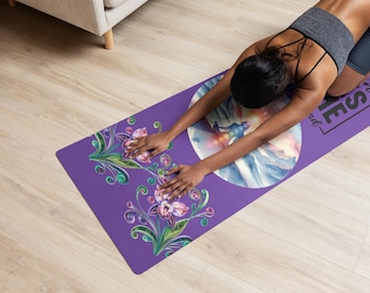 May include: Purple yoga mat with a watercolor design of a person meditating in a mountain landscape. The mat has a floral design on the bottom and the text "Find your inner peace" on the top.