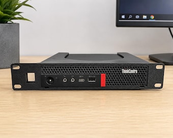 May include: A black ThinkCentre computer with a red accent, featuring multiple ports and the ThinkCentre logo. The computer is mounted in a rack and sits on a light-coloured wooden surface.