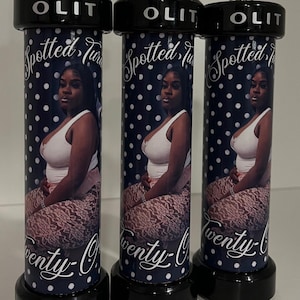 May include: Three cylindrical tumblers with black lids and bases, featuring a dark blue background with white polka dots, a photographic print of a person, and the text "OLIT", "Spotted", and "Twenty". Each tumbler includes a clear straw with a colored insert.