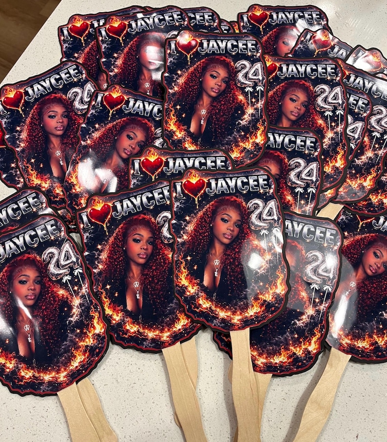 May include: A collection of personalized hand fans featuring a woman with long, curly red hair. Each fan has the name "JAYCEE" and the number "24" printed on it, surrounded by a fiery design and a heart.