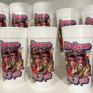 May include: White foam cups with a colorful graphic featuring a woman's image, the name "Dearra", and the phrase "Thirty Ta Turks". Some cups also display "Da Queen". The cups are arranged on a white surface.