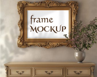 May include: A gold ornate picture frame with a white mat and the text "frame MOCKUP" inside. The frame is hanging on a beige wall above a wooden dresser with three drawers.