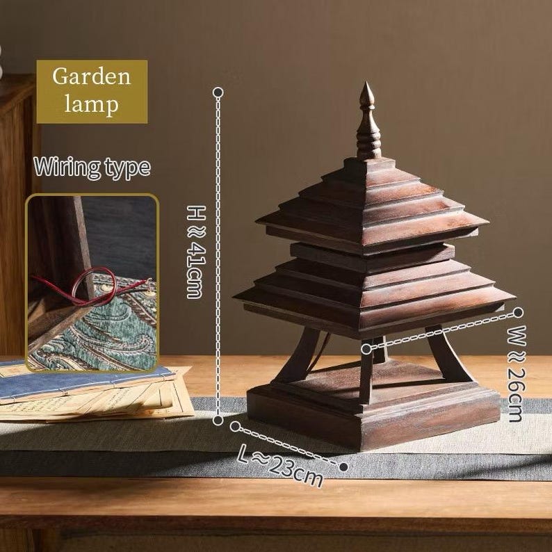 May include: A wooden garden lamp with a pagoda-style design. The lamp is approximately 16 inches tall, 10 inches wide, and 9 inches long. The lamp has a dark brown finish and is made of layered wooden panels. The text "Garden lamp" and "Wiring type" are visible.