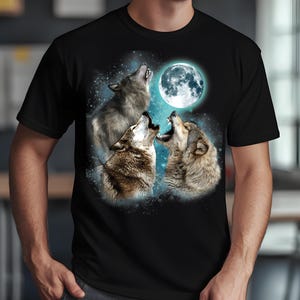 May include: A black t-shirt with a graphic of three wolves howling at the moon. The wolves are silhouetted against a blue and white starry sky.