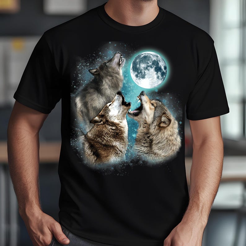 May include: A black t-shirt with a graphic of three wolves howling at the moon. The wolves are silhouetted against a blue and white starry sky.