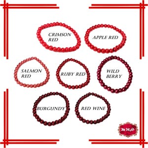 May include: Six red beaded bracelets with different shades of red. The bracelets are labeled with the following names: Crimson Red, Apple Red, Salmon Red, Ruby Red, Wild Berry, and Burgundy.