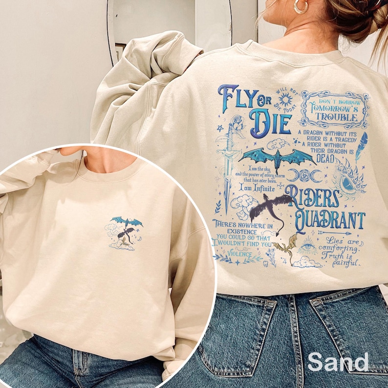 May include: Sand-colored sweatshirt with blue graphic text and illustrations. The design includes a dragon, sword, and phrases like "Fly or Die" and "Riders Quadrant." A smaller dragon graphic is on the front.