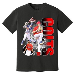 May include: Black t-shirt featuring baseball players in action, with the name "Alic" and the word "GOTS" in red and white. The number "10" is also visible on the shirt.