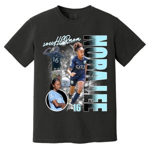 May include: Black t-shirt featuring a soccer player graphic with the name "Nopalee" in light blue. The shirt includes the text "soccer HER mom" and the number "16". The design incorporates action shots of the player.