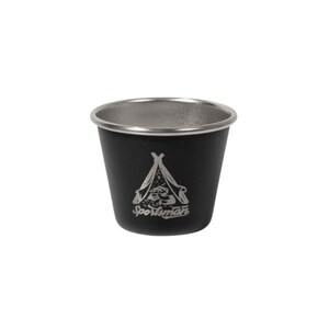 May include: A black metal camping cup with a silver rim. The cup has a white graphic of a tent and the word "Sportsman" in white. The cup is designed for outdoor use and is likely made of durable materials.