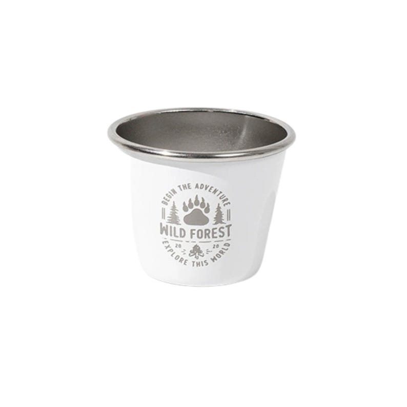 May include: White enamel camping mug with a silver rim. The mug features the text "Wild Forest" with a paw print and tree graphic. The text "Begin the adventure, explore this world" is also printed on the mug.