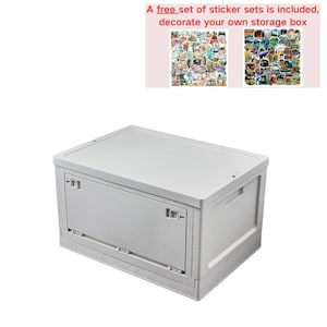 May include: A white plastic storage box with a folding lid. The box is closed and sitting on a white surface. A free set of sticker sets is included, decorate your own storage box.