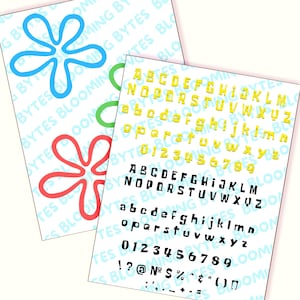 May include: A sheet of paper with a yellow alphabet, numbers, and punctuation marks printed in a bold, blocky font. The letters are outlined in black. The paper is on a white background.