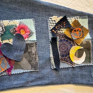 May include: Close-up of denim fabric with two patches. The left patch features a denim heart, a peace sign, and a floral design. The right patch has the word "LOVE" embroidered, a peace sign, and a crescent moon.