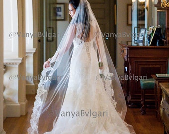 Cathedral wedding veil with beaded re-embroidered  lace on the edge starting at elbow level with gathered top on a hair comb, classic veil