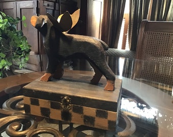 Carved Rottweiler  with wings ,on box with checks for use as urn  for memorial or home