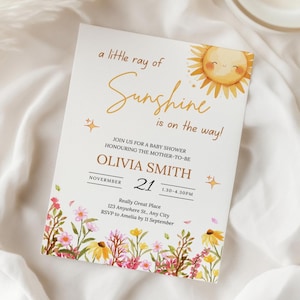 May include: A baby shower invitation with the text "a little ray of Sunshine is on the way!" features a smiling sun illustration and floral accents. The invitation includes the name Olivia Smith, the date November 21, and event details.