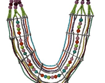 May include: A multi-strand statement necklace featuring rows of colorful glass beads in shades of orange, lime green, turquoise, purple, and pink, interspersed with metallic silver spacer bars that connect the strands in a tiered design.