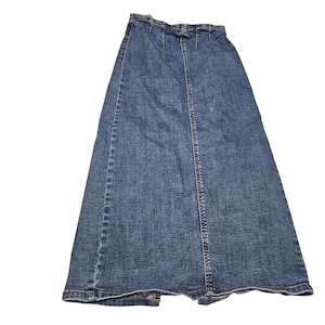 May include: A long, blue denim skirt with a classic design. The skirt features a button and zipper closure, a split in the back, and a faded wash. The skirt is made of a durable denim material.