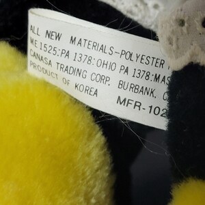 May include: A white tag with black text that reads "ALL NEW MATERIALS-POLYESTER ME 1525:PA 1378: OHIO PA 1378:MAS CANASA TRADING CORP. BURBANK. C PRODUCT OF KOREA MFR-102"