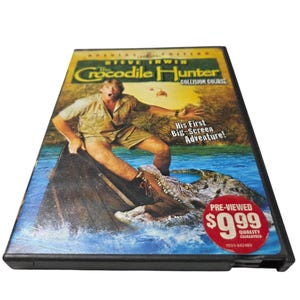 May include: A DVD case for "The Crocodile Hunter: Collision Course" featuring Steve Irwin. The cover shows Irwin in a boat, facing a crocodile. Text includes "His First Big-Screen Adventure!"