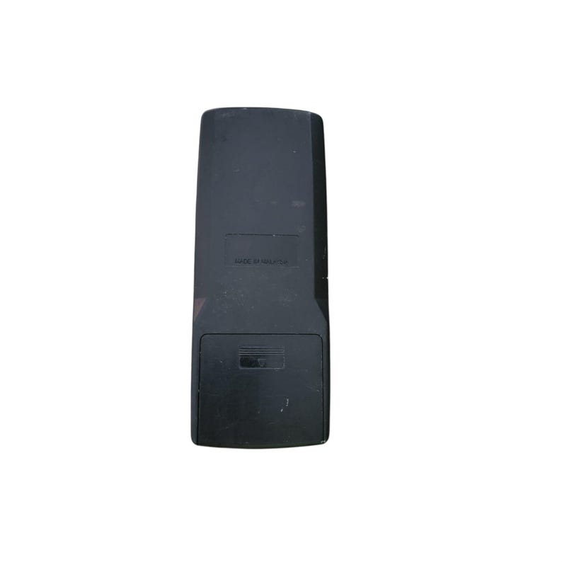 May include: A black rectangular remote control with a battery compartment at the bottom. The text "MADE IN MALAYSIA" is printed on the top portion of the remote. The remote has a slightly worn appearance.