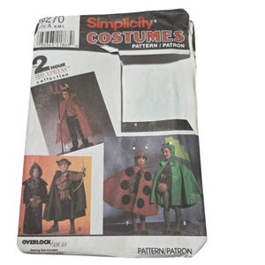 May include: A Simplicity Costumes sewing pattern envelope, number 9270, featuring illustrations of various children's costumes including a devil, a ladybug, a dragon, and historical-style outfits. The white paper packet displays the text 2 Hour Express.
