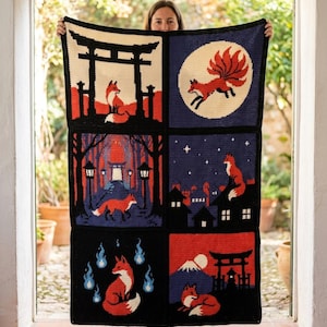 May include: A rectangular crochet blanket featuring six distinct panels with fox motifs in red, black, white, and blue. The designs include a torii gate, a nine-tailed fox, a forest path, a fox on a rooftop, blue flames, and a mountain landscape.